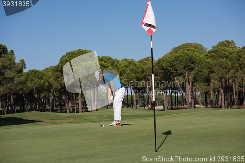 Image of golf player hitting shot at sunny day