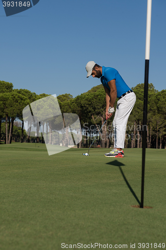 Image of golf player hitting shot at sunny day