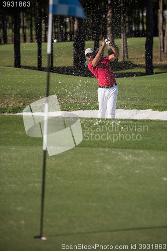 Image of golfer hitting a sand bunker shot