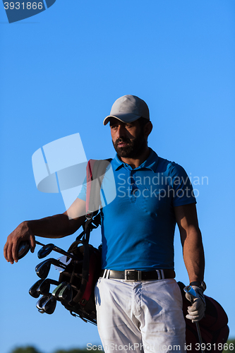 Image of golfer  portrait at golf course on sunset