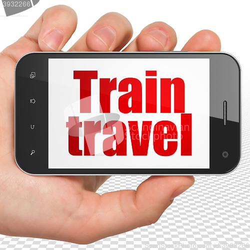 Image of Vacation concept: Hand Holding Smartphone with Train Travel on display