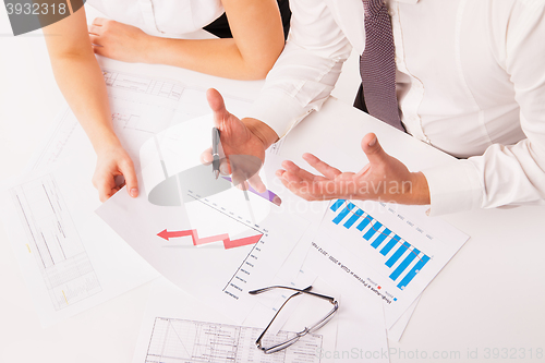 Image of Businessman and businesswoman discussing in office isolated