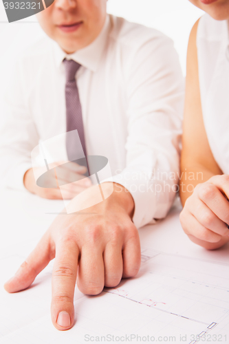 Image of Businesswoman and businessman pointing at document in office isolated