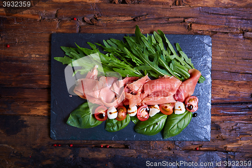 Image of plate of salad with cherry tomatoes, arugula,