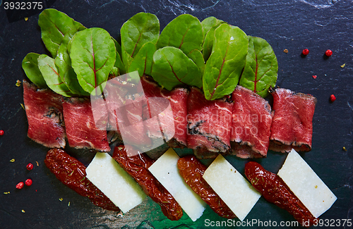 Image of slices ham with cheese and leaves of beets