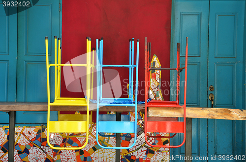 Image of Colorful chairs on a wooden table