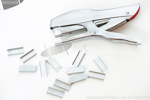 Image of Staples and stapler on white background