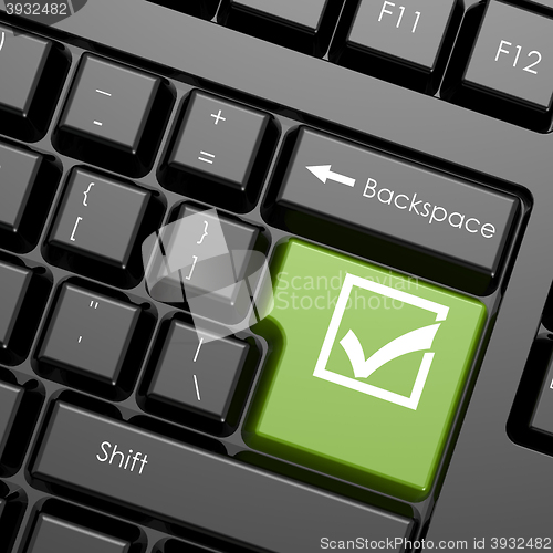 Image of Green enter button with check mark on black keyboard, isolated