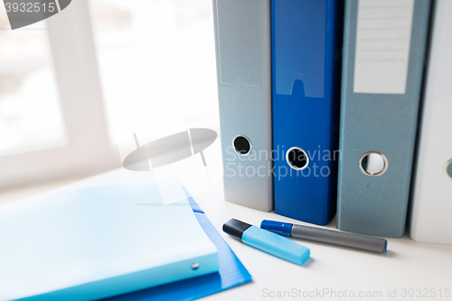 Image of close up of ring binders and files on office table