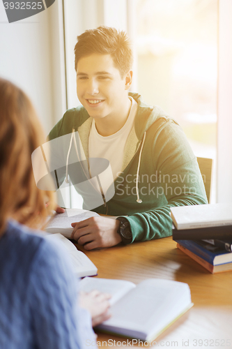 Image of students with books preparing to exam in library