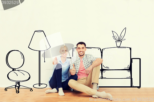 Image of happy couple showing thumbs up at new home