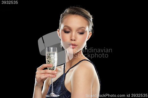 Image of young asian woman drinking champagne at party