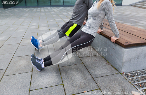 Image of close up of couple doing triceps dip on bench