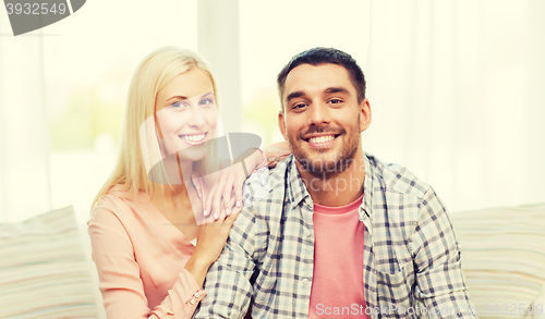 Image of smiling happy couple at home