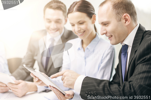 Image of business team with tablet pc having discussion