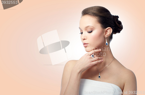 Image of beautiful woman with earring, ring and pendant