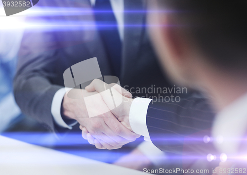 Image of two businessmen shaking hands in office