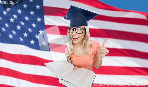 Image of student woman in mortarboard with encyclopedia