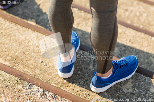 Image of close up of sporty man legs in shoes on stairs