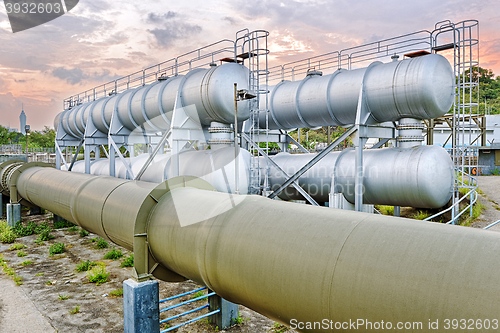 Image of Oil and gas industry refinery factory at sunset