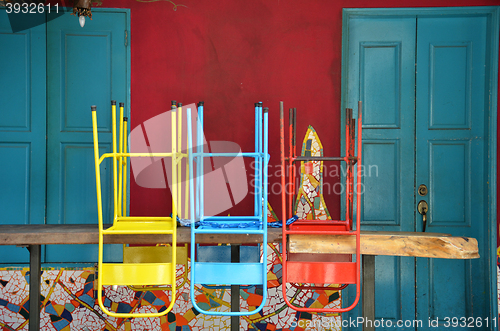 Image of Colorful chairs on a wooden table