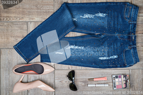 Image of Aerial  view of woman\'s jeans and accessories