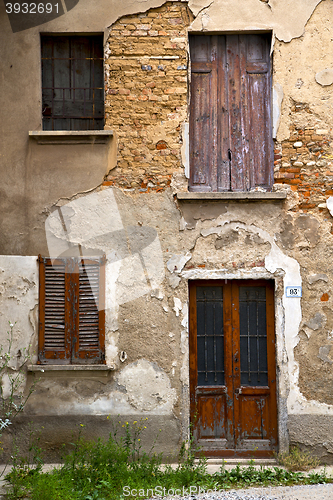 Image of brown door  europe    in  the milano   window closed brick grass