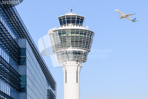 Image of Munich international airport control tower and departing taking off