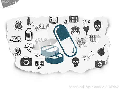 Image of Medicine concept: Pills on Torn Paper background