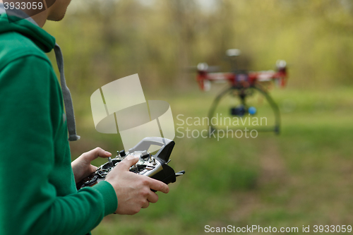 Image of Man controling a drone.