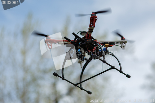 Image of flying drone with camera on the sky