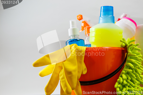 Image of Bucket with cleaning items on light background