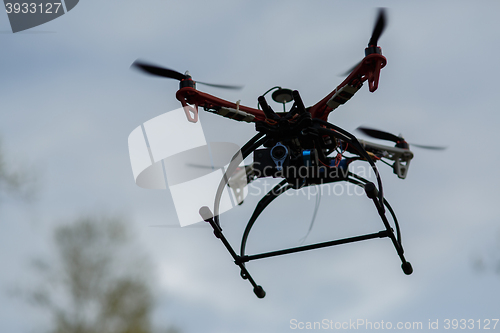 Image of flying drone with camera on the sky