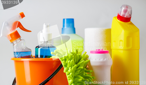 Image of Bucket with cleaning items on light background