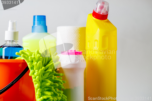 Image of Bucket with cleaning items on light background