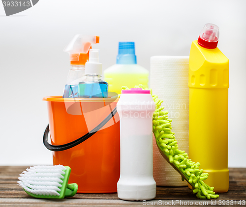 Image of Bucket with cleaning items on light background