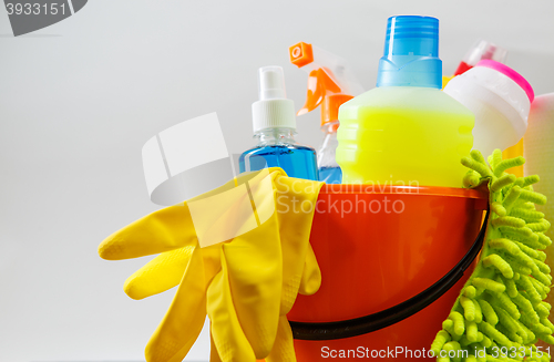 Image of Bucket with cleaning items on light background