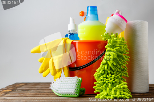 Image of Bucket with cleaning items on light background