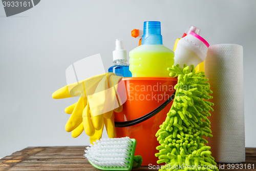 Image of Bucket with cleaning items on light background