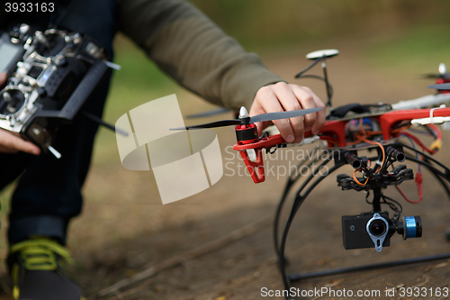 Image of Closeup of man hand fixing propeller drone 