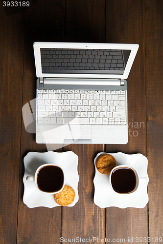 Image of Morning coffee for two and laptop