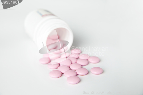Image of Close-up of pink scattered pill from bottle