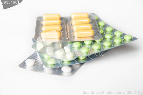 Image of Close-up of green and white pills in blisters