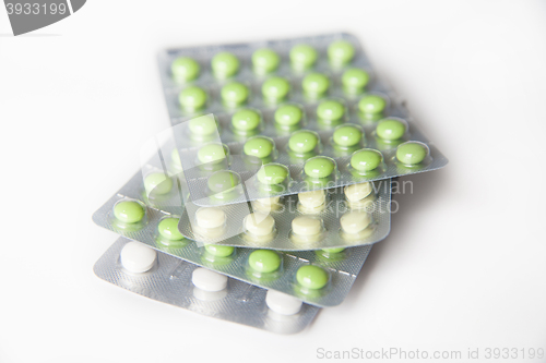 Image of Close-up of green and white pills in blisters