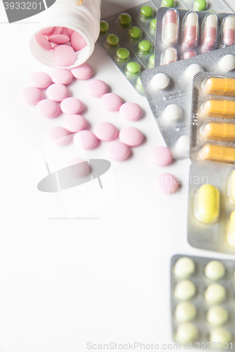 Image of Close-up of scattered pink and colorful tablets in blisters