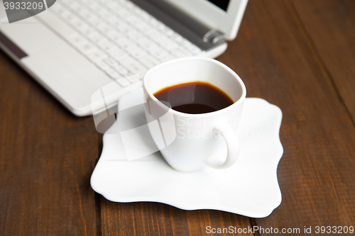 Image of Close-up of black coffee near laptop keyboard