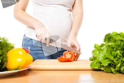 Image of Unrecognizable woman cutting tomato