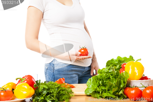 Image of Pregnant woman with tomato