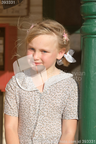 Image of girl leaning on pole