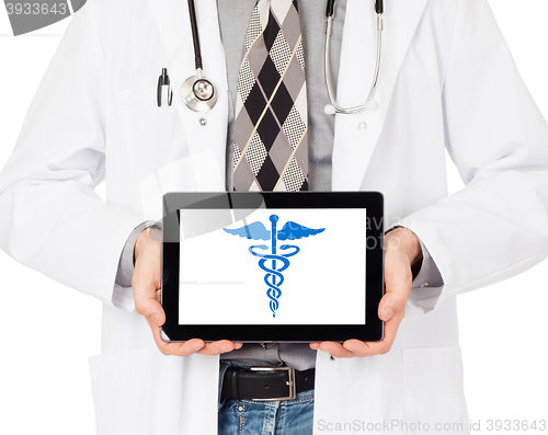 Image of Doctor holding tablet - Caduceus symbol